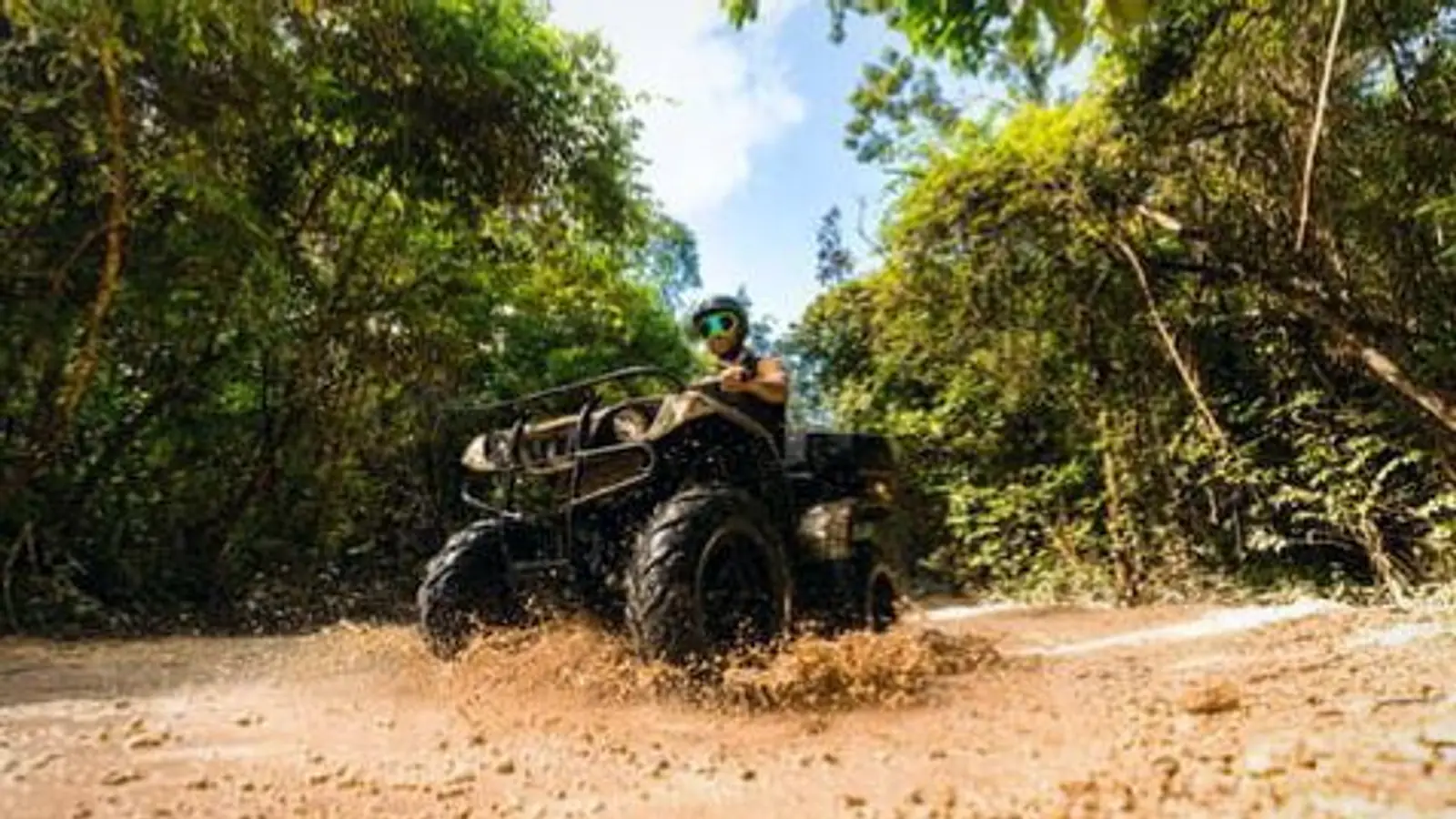 An ATV driving along a dirt track through the jungle — photo from the booking listing